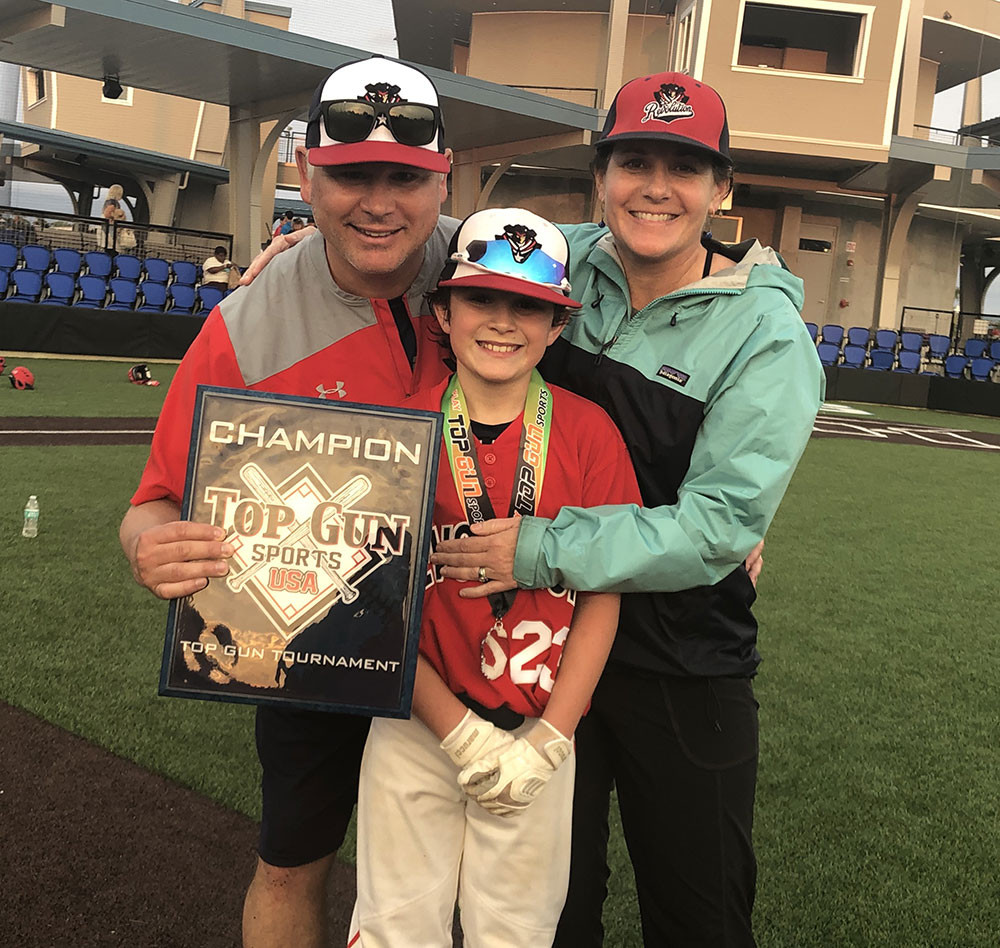Baseball Player With Parents Holding Award