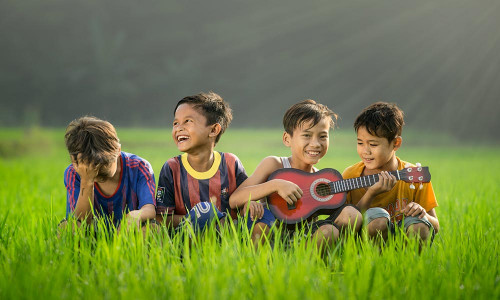 Photo of minors playing guitar